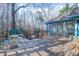 Large wooden deck with grill overlooking a wooded yard, steps leading to additional outdoor features at 94 Cedar Hills Cir, Chapel Hill, NC 27514