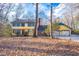 Two-story home with yellow siding, blue shutters, brick accents, and a two-car garage at 94 Cedar Hills Cir, Chapel Hill, NC 27514