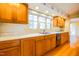 Bright kitchen features wood cabinets, a double sink, and lots of natural light at 94 Cedar Hills Cir, Chapel Hill, NC 27514