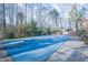 Closed pool with a cover and winterized surrounded by trees and nature at 94 Cedar Hills Cir, Chapel Hill, NC 27514