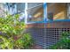 Lower level of a screened in porch, with lattice, water spigots, and plants at 94 Cedar Hills Cir, Chapel Hill, NC 27514