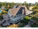 Aerial view of the community clubhouse featuring a stone chimney and an outdoor deck at 100 Highveld Ave, Chapel Hill, NC 27516