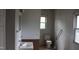 Bathroom featuring a sink, toilet, and a window at 1005 N Wilson Ave, Dunn, NC 28334