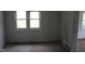 A basic room with a double window, radiator, and simple finishes at 1005 N Wilson Ave, Dunn, NC 28334