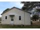 A view of the home's rear exterior, including the siding, access door and multiple windows at 1005 N Wilson Ave, Dunn, NC 28334