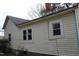 A view of the side of the home with traditional siding, windows, and trim details at 1005 N Wilson Ave, Dunn, NC 28334