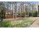 Large backyard with mature trees, partial view of the house and lawn at 1021 Whetstone Ct, Raleigh, NC 27615