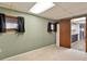 Carpeted basement with view to kitchenette and window at 1021 Whetstone Ct, Raleigh, NC 27615