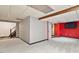 Spacious basement area with painted walls, stairs, red accent pole, and drop ceiling at 1021 Whetstone Ct, Raleigh, NC 27615