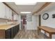 Basement with kitchenette area including dark cabinets and contrasting countertops at 1021 Whetstone Ct, Raleigh, NC 27615