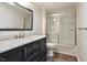 Updated bathroom with a marble countertop, sleek vanity, and a shower-over-tub with glass doors at 1021 Whetstone Ct, Raleigh, NC 27615