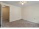 Carpeted bedroom featuring a ceiling fan and closet with an open door for easy access at 1021 Whetstone Ct, Raleigh, NC 27615