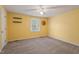 Bright bedroom with yellow walls, carpet flooring, and a window that allows natural light at 1021 Whetstone Ct, Raleigh, NC 27615