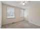 Bedroom with carpet flooring, two windows for natural light and a ceiling fan at 1021 Whetstone Ct, Raleigh, NC 27615