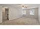 Bright bedroom with carpet, a ceiling fan, and two large windows at 1021 Whetstone Ct, Raleigh, NC 27615
