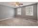 Bedroom featuring carpet flooring, two windows for natural light and neutral grey walls at 1021 Whetstone Ct, Raleigh, NC 27615