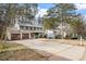Traditional two-story home with attached garage and long driveway, surrounded by mature trees at 1021 Whetstone Ct, Raleigh, NC 27615
