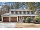 Charming two-story home boasts a brick facade, front porch and attached two-car garage at 1021 Whetstone Ct, Raleigh, NC 27615