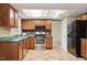 The kitchen features wood cabinets, stainless appliances and a brick backsplash at 1021 Whetstone Ct, Raleigh, NC 27615