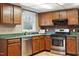 Kitchen featuring wood cabinets, stainless appliances, and a large window view at 1021 Whetstone Ct, Raleigh, NC 27615