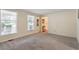 Neutral living room with carpet, natural light, and a view into the hallway at 1021 Whetstone Ct, Raleigh, NC 27615
