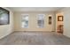 Bright and spacious living room with carpeted floors and large windows, offering ample natural light at 1021 Whetstone Ct, Raleigh, NC 27615