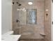 Modern shower with mosaic tile accent, tiled walls, rainfall shower head and built-in seat at 1021 Whetstone Ct, Raleigh, NC 27615