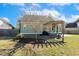 Backyard area featuring a hot tub, fountain, wooden pergola, mature trees and lush green grass at 1024 Jensen Grove Ct, Fuquay Varina, NC 27526