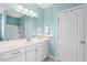 Bathroom featuring a white vanity with ample storage, a large mirror, and a door leading to another room at 1024 Jensen Grove Ct, Fuquay Varina, NC 27526