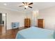 Spacious bedroom with hardwood floors, ceiling fan, doors, and a variety of wooden dressers for storage at 1024 Jensen Grove Ct, Fuquay Varina, NC 27526