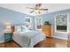 Cozy bedroom with a ceiling fan, natural light, and hardwood floors at 1024 Jensen Grove Ct, Fuquay Varina, NC 27526