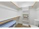 Organized walk-in closet featuring built-in shelving, clothing rods, carpeted flooring, and accent table at 1024 Jensen Grove Ct, Fuquay Varina, NC 27526