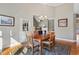 Dining room that flows into living room, featuring hardwood floors and access to the deck at 1024 Jensen Grove Ct, Fuquay Varina, NC 27526