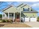 Charming two-story home with a welcoming porch and a two-car garage in a manicured front yard at 1024 Jensen Grove Ct, Fuquay Varina, NC 27526