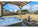 Enjoy the backyard with hot tub, pergola, fountain and large yard, perfect for outdoor living at 1024 Jensen Grove Ct, Fuquay Varina, NC 27526