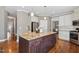 Spacious kitchen with a central island, white cabinets, and hardwood floors at 1024 Jensen Grove Ct, Fuquay Varina, NC 27526