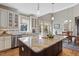 Modern kitchen with a large island, granite countertops, and stainless steel appliances at 1024 Jensen Grove Ct, Fuquay Varina, NC 27526