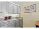 This kitchenette provides stylish grey cabinetry, a small sink, and light countertops at 1024 Jensen Grove Ct, Fuquay Varina, NC 27526