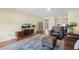 The living room features a plush area rug, hardwood floors, and neutral wall colors at 1024 Jensen Grove Ct, Fuquay Varina, NC 27526