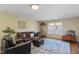 Cozy living room with hardwood floors, a large window, and comfortable seating at 1024 Jensen Grove Ct, Fuquay Varina, NC 27526
