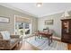 Sunlit office featuring a patterned chair, desk, and large window with backyard views at 1024 Jensen Grove Ct, Fuquay Varina, NC 27526