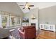 Bright and inviting living room with fireplace, large windows offering views to the backyard at 1024 Jensen Grove Ct, Fuquay Varina, NC 27526