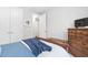 Comfortable bedroom featuring a wooden dresser and a window, creating a bright and welcoming space at 105 Olde Liberty Dr, Youngsville, NC 27596