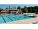 Resort-style community pool with lounge chairs and well maintained brick building at 105 Olde Liberty Dr, Youngsville, NC 27596