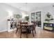 Charming dining area with a wooden table, decorative sideboard, and patio access at 105 Olde Liberty Dr, Youngsville, NC 27596