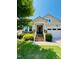 Charming home featuring a covered porch, brick steps, stone accents, and a well-manicured lawn under a clear blue sky at 105 Olde Liberty Dr, Youngsville, NC 27596