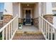 Inviting front porch with stone accents, decorative wreath, and a cozy, welcoming ambiance at 105 Olde Liberty Dr, Youngsville, NC 27596