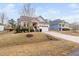 Beautiful home with a well-manicured front yard, a two car garage and a stone pathway to the front door at 105 Olde Liberty Dr, Youngsville, NC 27596