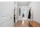 Bright hallway featuring wood floors, white trim, laundry closet, and an inviting, well-lit atmosphere at 105 Olde Liberty Dr, Youngsville, NC 27596