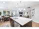 Open-concept kitchen with a large island, stainless steel appliances, and hardwood floors connecting to the living and dining areas at 105 Olde Liberty Dr, Youngsville, NC 27596